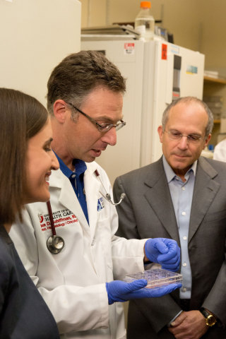 Juliette Feld, Executive Vice President of Feld Entertainment, learns more about cancer research and comparing the P53 gene from Dr. Joshua Schiffman, Pediatric Oncologist from Primary Children’s Hospital and Investigator with Huntsman Cancer Institute, both located in Salt Lake City, UT, with Kenneth Feld, Chairman and CEO of Feld Entertainment, in Dr. Schiffman’s lab at the Hunstman Cancer Institute. (Photo: Feld Entertainment)