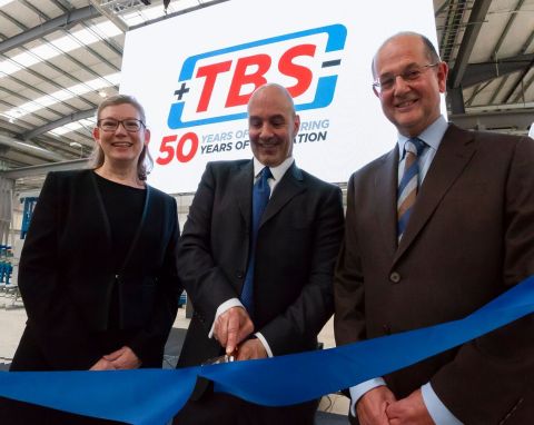 Tom Valvo, MiTek Industries Chief Operating Officer cuts the ribbon at the opening ceremony of TBS Engineering’s new £15m HQ in the UK. From left to right: Viv Empson, TBS Group Finance and HR Director; Tom Valvo, MiTek Industries COO; and David Longney, TBS Group Managing Director. (Photo: Business Wire)