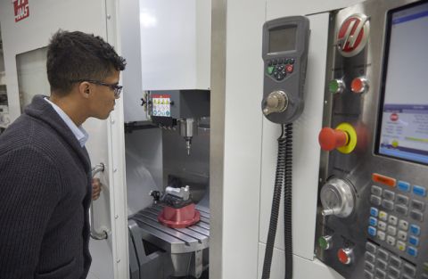 A technician performing setup and machining of a 15-5 stainless steel aerospace part, which was 3D printed using Laser Powder Bed Fusion on an EOS M290 3D printer. (Photo: Business Wire)