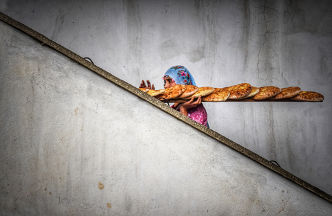 「日常生活中的混凝土」主題專業組冠軍：Niyazi Gürgen @niyazi_gurgen。土耳其。「我的這張照片取景於土耳其安納托利亞的一個古老村莊。我想透過這張照片記錄婦女在這一地區艱苦的生活條件，以及她們堅忍不拔的精神。透過單張作品來展現日常生活技能和能力是一件十分困難的事情，但我成功地以一種富有美感的方式捕捉到了這一畫面。就在這位婦女調整肩上背負的長麵包之際，她坦然接受了生活中的所有困難，並努力地維持著家庭的生計。在這些混凝土樓梯上，她已經上上下下走了無數次。面對每天不得不從事的繁重工作，這些樓梯也讓她能夠稍稍輕鬆了一點。」（照片：美國商業資訊）