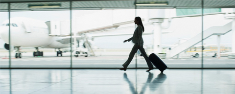Passenger walks through an airport terminal on the way to catch a flight. Cirium, the aviation analytics company, has published its 2022 On-Time Performance rankings, looking at the top performing airlines and airports worldwide. The definitive, world-leading analysis recognises excellence in punctuality by the aviation industry globally. (Photo: Business Wire)