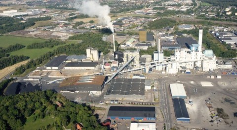 合成照片，由Scheiwiller Svensson Arkitektkontor AB制作。该图片展示了block 7的地理位置，即发电厂后方金色和黑色的建筑，从南面拍摄。