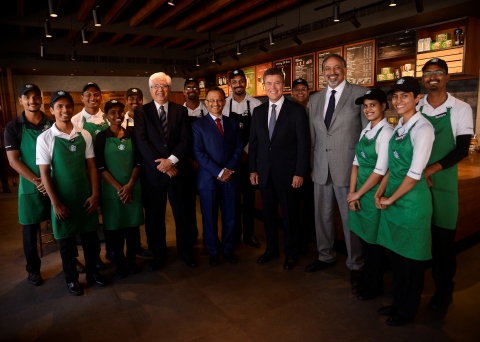 Surrounded by Tata Starbucks partners (employees), (from L-R) Ajoy Misra, chief executive officer and managing director, Tata Global Beverages; Harish Bhat, Brand Custodian, Tata Sons; John Culver, group president, Starbucks International and Channel Development; with Sumi Ghosh, chief executive officer, Tata Starbucks, celebrate the company’s opening of the Victoria Mills store – the 100th store in Mumbai, India – and five-year market anniversary. (Photo: Business Wire)