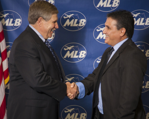 Melbourne International Airport Executive Director Richard A. Ennis congratulates Archo Solutions Engineering USA CEO Dirley Giacomini during a lease signing ceremony at the airport earlier this month. (Photo: Business Wire)
