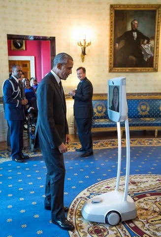 Barack Obama greets Alice Wong, founder and project coordinator of the Disability Visibility Project, via Beam during the Americans with Disabilities Act 25th anniversary reception in the Blue Room of the White House, July 20, 2015. (Official White House Photo by Pete Souza).