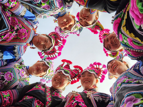 Women from the Art Ensemble “Huobonuoma,” or “Daughters of the Moon,” showcasing their Yi embroidered costumes, an ancient handcraft representing the cultural heritage of the Yi ethnic group. Through the project, Yi women were supported to develop their Yi embroidery business resulting in an increase in their income. For instance, the per capita income of villagers in 2017 was RMB 11,080 and this grew to RMB 14,128 in 2021. (Photo: Courtesy of Waipula Villagers)