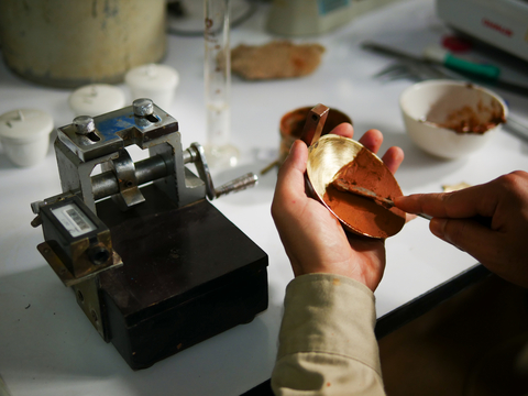A lab technician is pictured conducting an Atterberg limits test. Geotechnical labs can generate Atterberg limits test certificates from raw lab test data in OpenGround. Atterberg limits tests reveal soil behaviour under moisture changes, guiding geotechnical engineers in soil classification and foundation design for civil infrastructure projects.