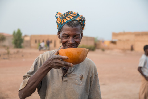 一名来自布基纳法索瓦加杜古城外的妇女在自己的村庄饮用RAIN项目供给的安全水。（照片：美国商业资讯） 