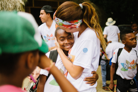 A counselor hugging a camper at the end of their immersive peace and reconciliation experience at Camp Bakongo in Colombia. (Photo: Business Wire)